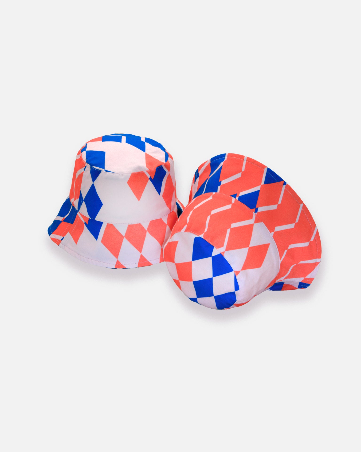 Two geometric-patterned bucket hats on a gray background