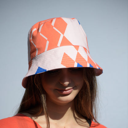 Young woman with the Kristina Nordöf bucket hat in pink, coral, cornflower blue