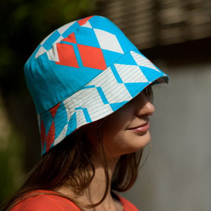 Young woman with the Kristina Nordöf bucket hat in turquoise, beige, raspberry red